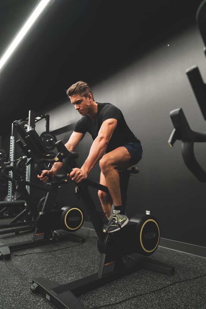 A man riding an exercise bike in a gym