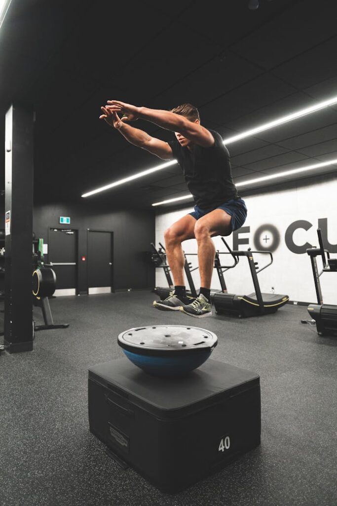 A man doing a jump on a balance board